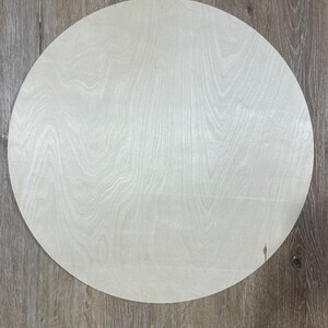May include: A round, unfinished, light wood circle, perfect for crafting projects.