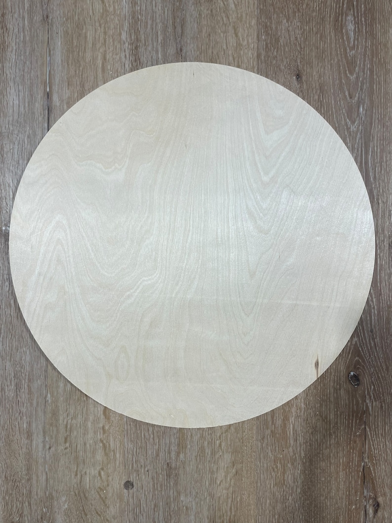 May include: A round, unfinished, light wood circle, perfect for crafting projects.