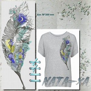 May include: A grey t-shirt with a feather design featuring a cityscape with blue, yellow, and teal accents. The design is approximately 7.8 x 20 cm. The image also shows a cross-stitch of the same design and teal ribbon.