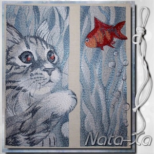 May include: A gray tabby cat with green eyes looks at a red and orange fish swimming in a blue and white underwater scene. The image is embroidered on a beige fabric.