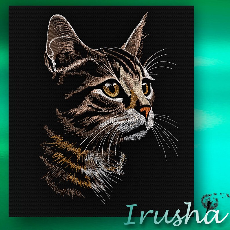 May include: A close-up of a brown tabby cat with white markings. The cat has green eyes and is looking to the right. The cat's fur is detailed with embroidery stitches.