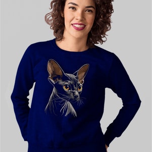 May include: A navy blue sweatshirt with a white embroidered image of a black Sphynx cat.