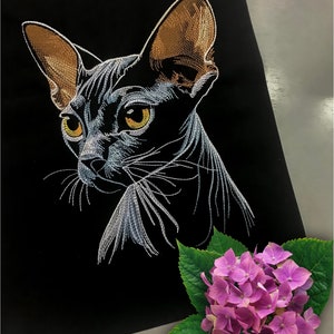 May include: A white embroidered image of a hairless cat with brown ears on a black background. A pink hydrangea flower with green leaves is in the bottom right corner.