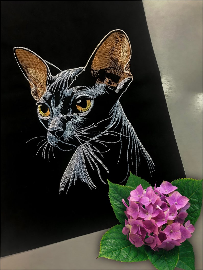 May include: A white embroidered image of a hairless cat with brown ears on a black background. A pink hydrangea flower with green leaves is in the bottom right corner.