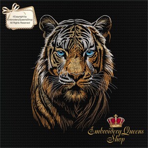 May include: Embroidered design of a tiger's face with blue eyes, gold and white fur, on a black background. The design includes the text "Embroidery Queens Shop" and a gold crown.