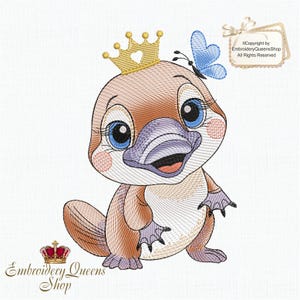 May include: Embroidered design of a cartoon platypus wearing a gold crown with a heart cutout and a blue butterfly on its head. The platypus is brown with a purple beak and blue eyes. The design is perfect for embroidery projects.