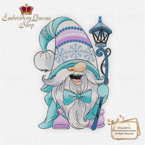 May include: Embroidered design of a blue and white gnome wearing a hat with snowflakes and holding a blue lamppost. The gnome has a white beard and a blue bow tie. The design is perfect for a winter or holiday themed project.