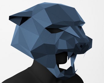 May include: A blue papercraft mask of a snarling panther head. The mask is made of folded paper and has a geometric design.