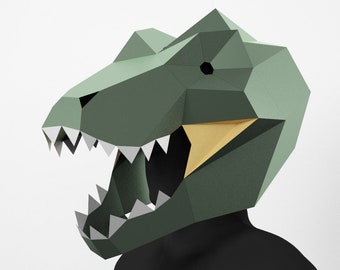 May include: A green and yellow papercraft dinosaur mask with a large open mouth and sharp teeth.