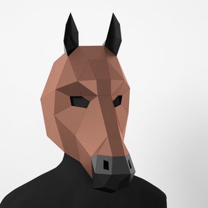 May include: A brown paper mache horse mask with black ears and a black nose. The mask is made of folded paper and has a geometric design.