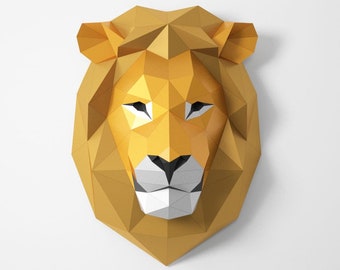 May include: A golden papercraft lion's head with a white muzzle and black eyes. The lion head is made of folded paper and has a geometric design.