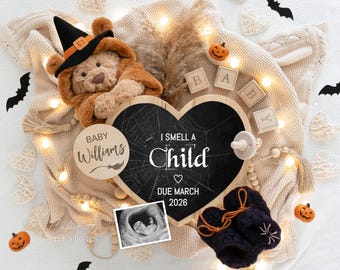 May include: A Halloween-themed pregnancy announcement with a teddy bear in a witch hat, a heart-shaped chalkboard reading "I smell a child," and baby booties. Includes a sonogram image, wooden blocks spelling "BABY," and decorative pumpkins.