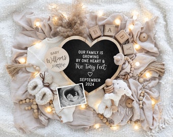 May include: A heart-shaped chalkboard with the text "Our family is growing by one heart & two tiny feet" and the date "September 2024". A wooden circle with the text "Baby Williams" is also in the image, along with a baby ultrasound image, a wooden rattle, and a stuffed lamb.