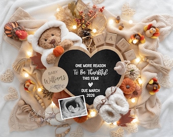 May include: A heartwarming announcement featuring a teddy bear in a white hooded outfit, a heart-shaped chalkboard with the text "ONE MORE REASON To Be Thankful THIS YEAR DUE MARCH 2026", and a sonogram. The scene includes baby booties, pumpkins, and decorative elements.