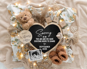 May include: A wooden heart-shaped chalkboard with the text "Spring is in the air and we have exciting news to share" and the date "September 2025". A wooden circle with the text "Baby Williams" is in the image. There are also wooden blocks that spell out "Baby", a teddy bear, a baby's ultrasound image, and a pair of brown knitted baby booties.