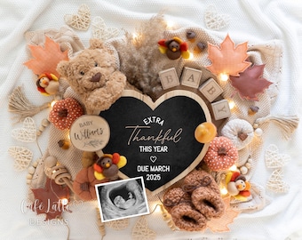 May include: A heart-shaped chalkboard with the text "Extra Thankful This Year" and a due date of March 2025. The chalkboard is surrounded by fall-themed decorations, including a teddy bear, pumpkins, and leaves.