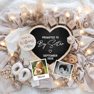 May include: A wooden heart-shaped chalkboard sign with the text "Promoted to Big Sister" and the date "September 2025".  A wooden circle with the text "Baby #2 Williams" is also in the image.  The sign is surrounded by a white blanket, wooden blocks, and a string of lights.