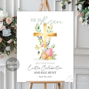 May include: A white Easter celebration sign with the words "He is Risen" above a gold cross and floral accents. The sign also reads "Welcome to our Easter Celebration and Egg Hunt - April 5th, 2025."
