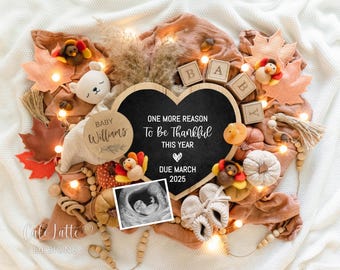 May include: A heart-shaped chalkboard with the text "One More Reason To Be Thankful This Year, Due March 2025" is surrounded by fall-themed decorations. The image includes baby booties, a sonogram, and toy turkeys.