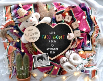 Può includere: Una lavagna a forma di cuore con il testo "Let's Taco 'Bout A Baby" e la data "Novembre 2024". La lavagna è circondata da una colorata coperta messicana, un orsacchiotto con un sombrero, blocchi di legno che compongono la parola "BABY", un cactus e un'immagine ecografica di un bambino.