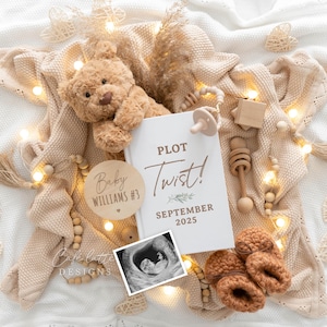 May include: A white card with the text "Plot Twist!" and "September 2025" on it. A wooden circle with the text "Baby Williams #3" is next to the card. A teddy bear, a baby rattle, and a string of lights are also in the image.