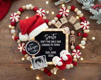 May include: A Christmas-themed baby announcement with a letter board that reads "Santa isn't the only one coming to town" and a due date of June 2024. The announcement also includes a wooden ornament with the text "Baby Robinson", a Santa hat, baby booties, and a sonogram image.