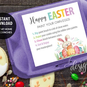 May include: A purple egg carton with a white card that reads "Happy Easter, Paint Your Own Eggs." The card features a bunny and decorated eggs. The text "Instant Download" and dimensions 3.25 x 3 inches are also visible.