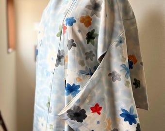 May include: A light blue kimono with a floral pattern in shades of blue, red, green, and yellow. The kimono is made of a soft, silky fabric and has a traditional Japanese design.