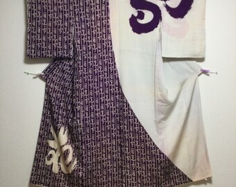May include: A traditional Japanese kimono with a white background and purple calligraphy-style designs. The kimono is made of silk and has a long, flowing silhouette.