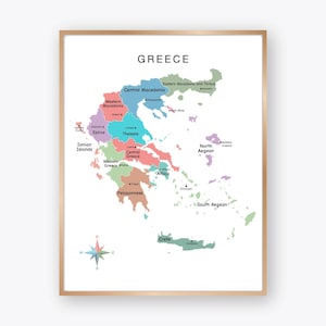 May include: A framed map of Greece, showcasing its regions in various colors. The map includes labels for each region, such as Central Macedonia, Epirus, and Crete. A compass rose is in the lower left corner.