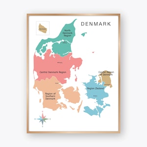 May include: A framed map of Denmark, showcasing the country's regions in various colors. The map includes labels for North Denmark, Central Denmark, Region of Southern Denmark, Region Zealand, and Capital Region of Denmark. A compass rose is at the bottom.