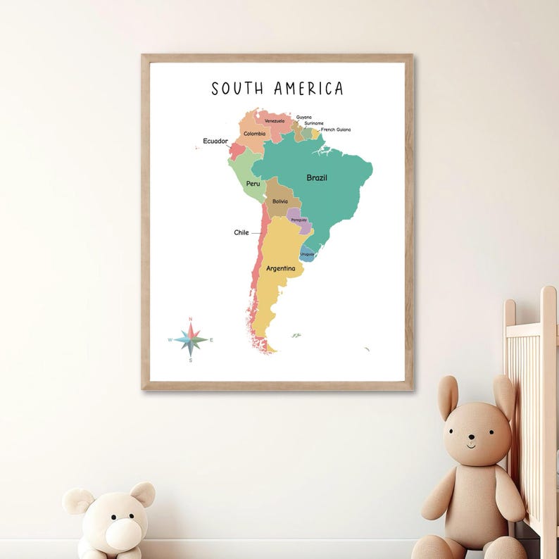 May include: A colorful map of South America with each country labeled. The map is framed in a light wood frame and is hanging on a white wall.