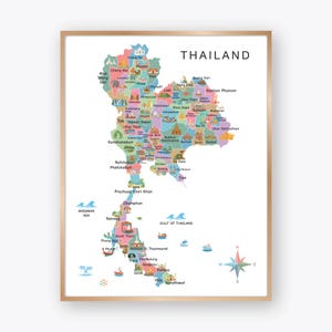 May include: A framed map of Thailand, with a colourful illustration of the country's provinces. The map includes the text "THAILAND" at the top and is decorated with small illustrations of boats, landmarks, and a compass rose. The frame is a light brown colour.