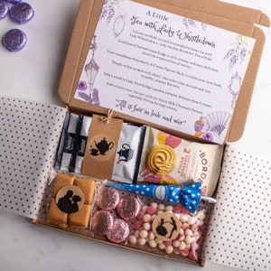 May include: A gift box filled with tea, biscuits, fudge, and candy. The box is decorated with a floral pattern and the text "A Little Tea with Lady Whistledown".