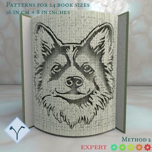Puede incluir: Un libro abierto con un diseño de perro corgi tallado. Las páginas están cortadas para formar la cara del perro. El texto en la parte superior dice "PATTERNS FOR 24 BOOK SIZES 16 CM + 8 IN INCHES". El libro tiene una lomo verde y está sobre una superficie clara.