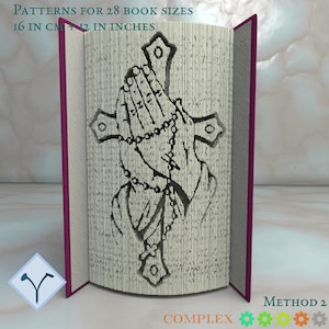 May include: A book with a paper cut-out design of a pair of hands holding a rosary and a cross. The book is open and the design is visible. The text "METHOD 2 COMPLEX" is visible at the bottom of the image.
