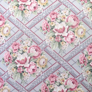 May include: Floral fabric featuring bouquets of pink and yellow roses, with white and green accents, set against a gray background with a red trellis pattern. The fabric has a vintage, romantic aesthetic.