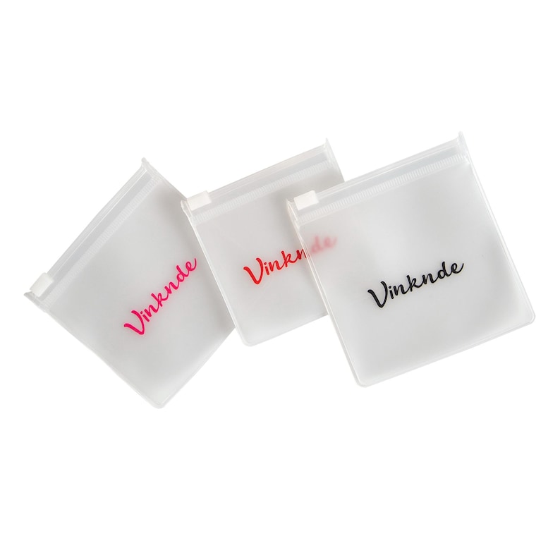 Puede incluir: Tres bolsas de pl&aacute;stico transparente con cierre de cremallera con la palabra "Vinknde" impresa en cada bolsa. Las bolsas est&aacute;n apiladas una encima de la otra. La palabra "Vinknde" est&aacute; impresa en rosa en la bolsa superior, en rojo en la bolsa del medio y en negro en la bolsa inferior.