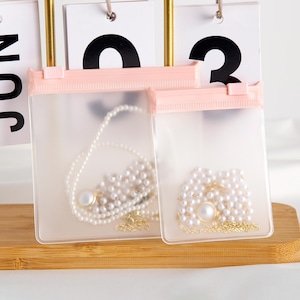 Sacchetto con cerniera per gioielli satinato opaco senza logo con cerniera rosa, confezione per gioielli di alta qualità, sacchetto per braccialetti, sacchetto per collane, sacchetto per anelli