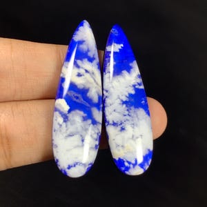 May include: A set of three ceramic mugs with a speckled, matte finish. The mugs are in shades of cream, light gray, and dark gray. Each mug has a simple, minimalist design and a rounded handle.