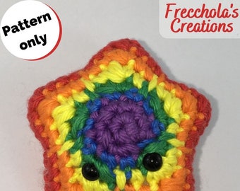 May include: A rainbow crocheted star with black eyes. The star is made with red, orange, yellow, green, blue, indigo, and violet yarn.