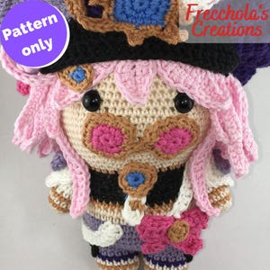 May include: A crocheted doll with a black hat, pink hair, and a pink bow. The doll has large black eyes and is wearing a multi-coloured outfit. The text "Pattern only" is in a purple circle. The text "Frecchola's Creations" is in the upper right corner.