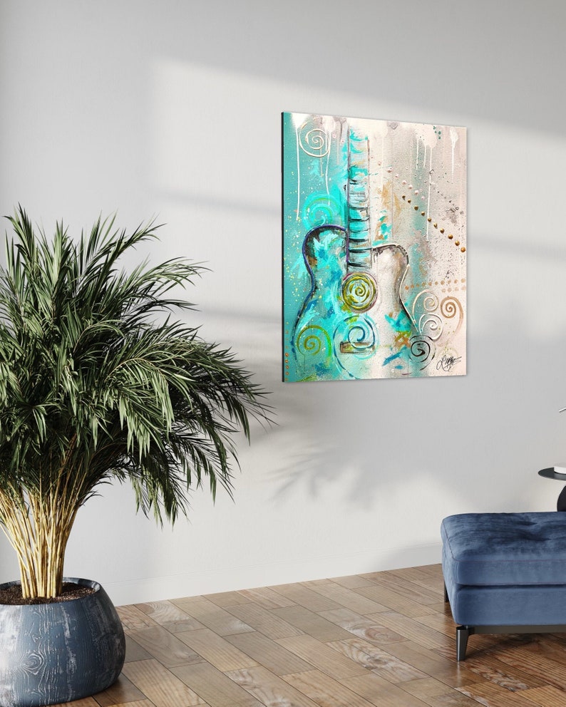 May include: Abstract painting of a teal and white acoustic guitar with gold and green accents. The background is a light blue with white and gold swirls.