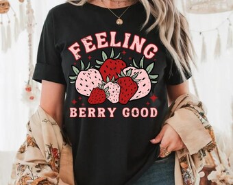May include: Black t-shirt with a graphic of strawberries and the text "Feeling Berry Good".