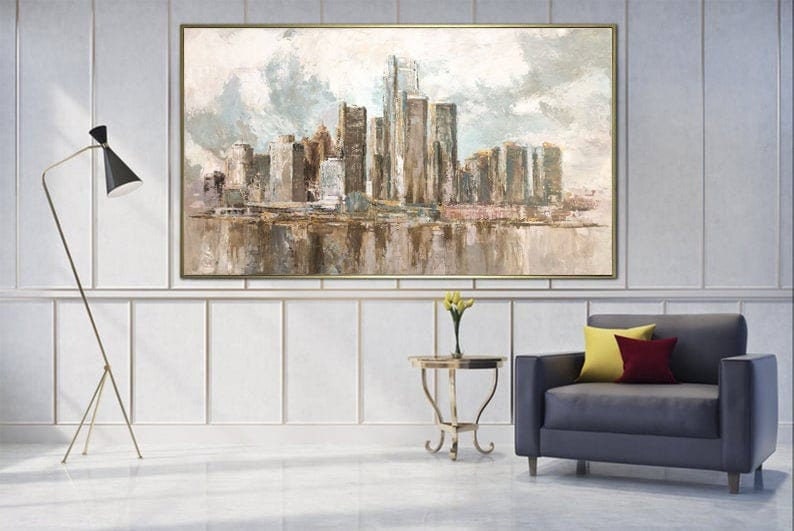 Neutral-toned abstract city skyline painting with skyscrapers and reflective water, displayed in a modern living room.