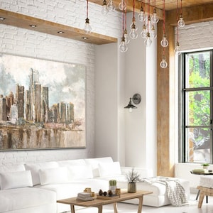 Neutral-toned abstract city skyline painting with skyscrapers and reflective water, displayed in a modern living room.