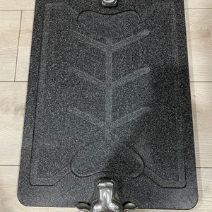 May include: Black granite serving tray with three silver bull head handles. The tray has a raised design in the center.