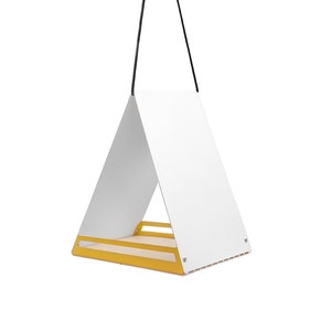 May include: A white triangular bird feeder with a yellow base hangs from a black cord. The feeder has a small platform for birds to perch on.