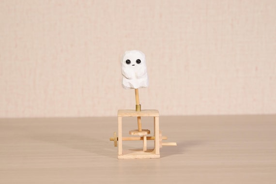 A cute wooden ghost automaton that bobs and moves mechanically — charming spooky-season desk art that works year-round for the whimsical crowd.