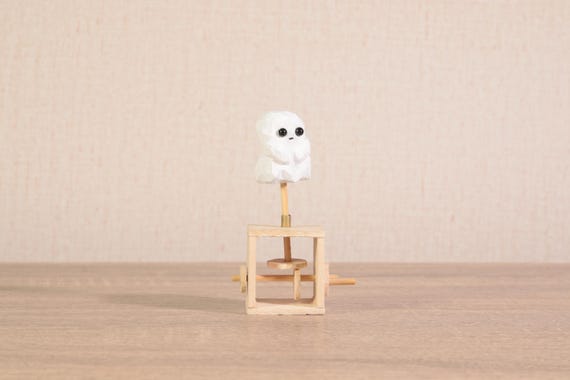A cute wooden ghost automaton that bobs and moves mechanically — charming spooky-season desk art that works year-round for the whimsical crowd.